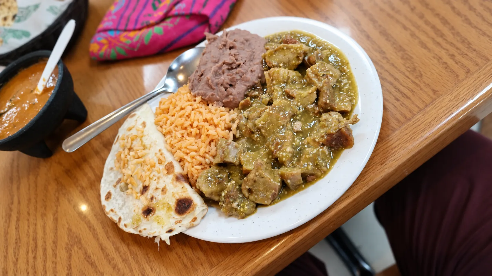 Stew in green salsa with rice, beans and a flour tortilla