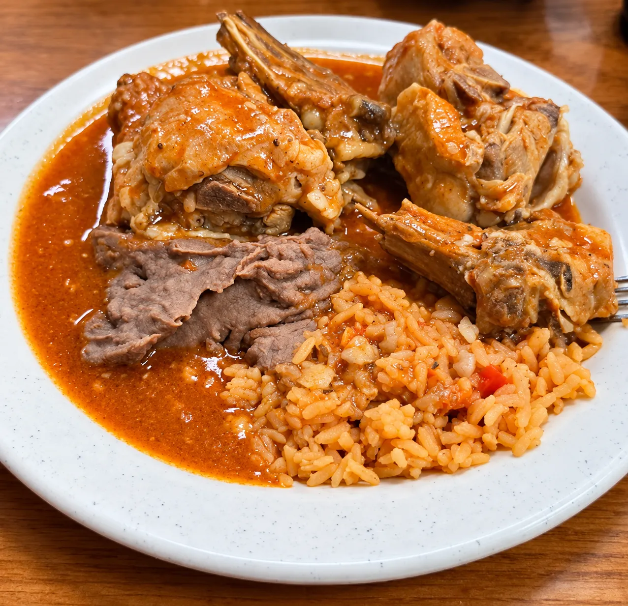 Ribs in red salsa with beans and rice