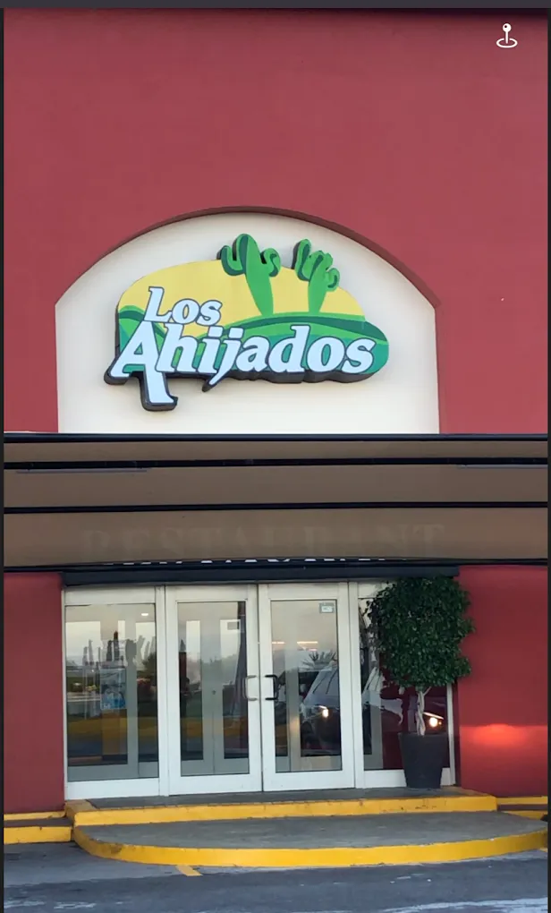 Entrance of the Los Ahijados restaurant with its logo sign