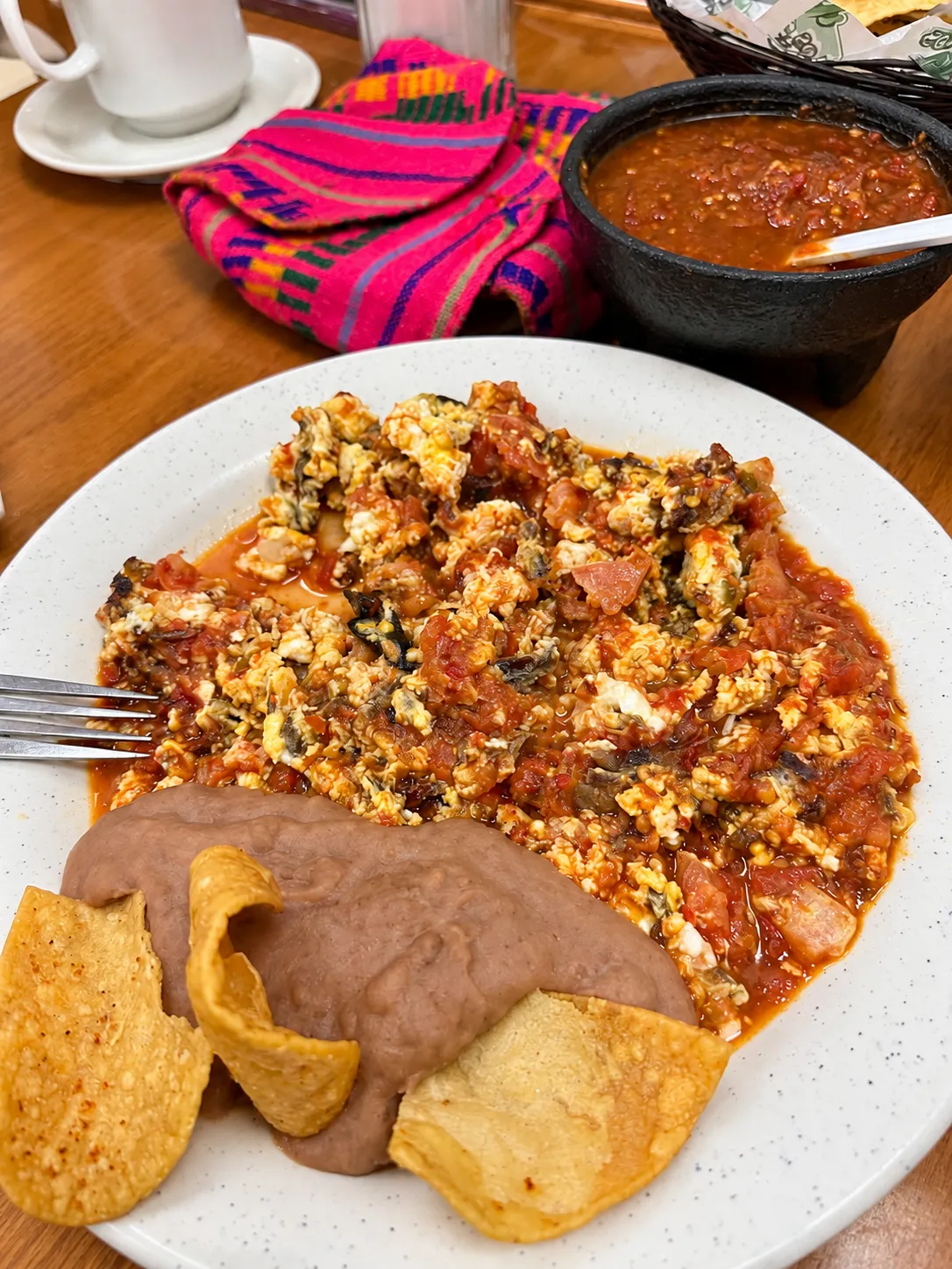 Machacado with eggs in red salsa, beans and chips