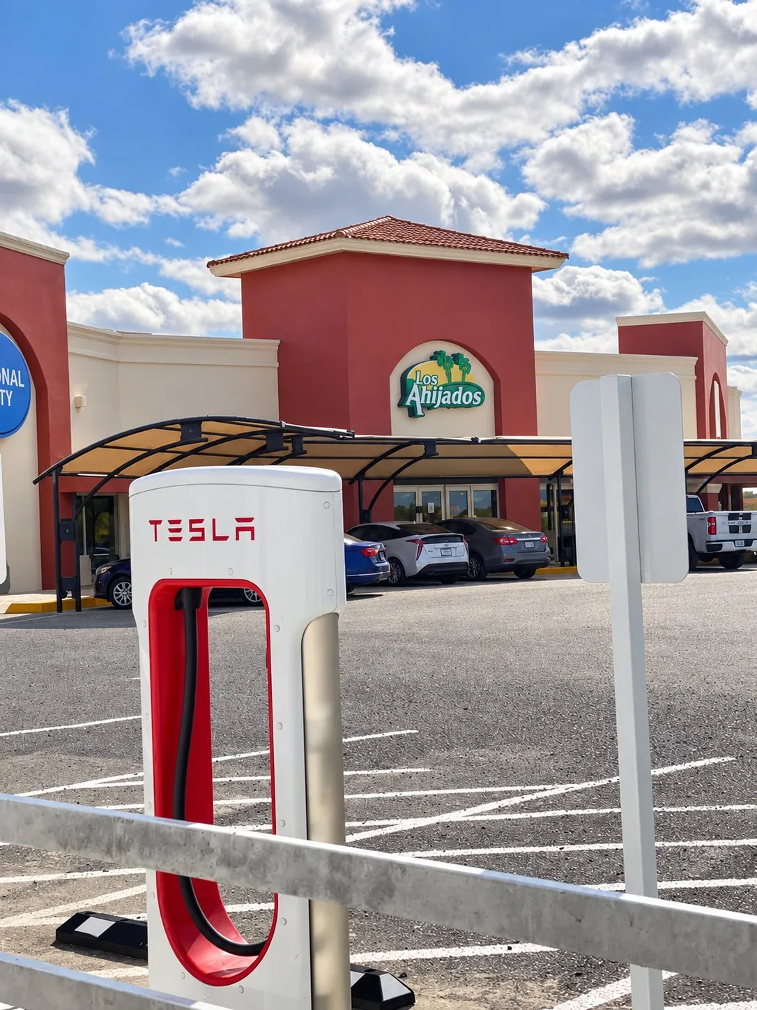Tesla Supercharger with the Los Ahijados restaurant behind it, km 98.5